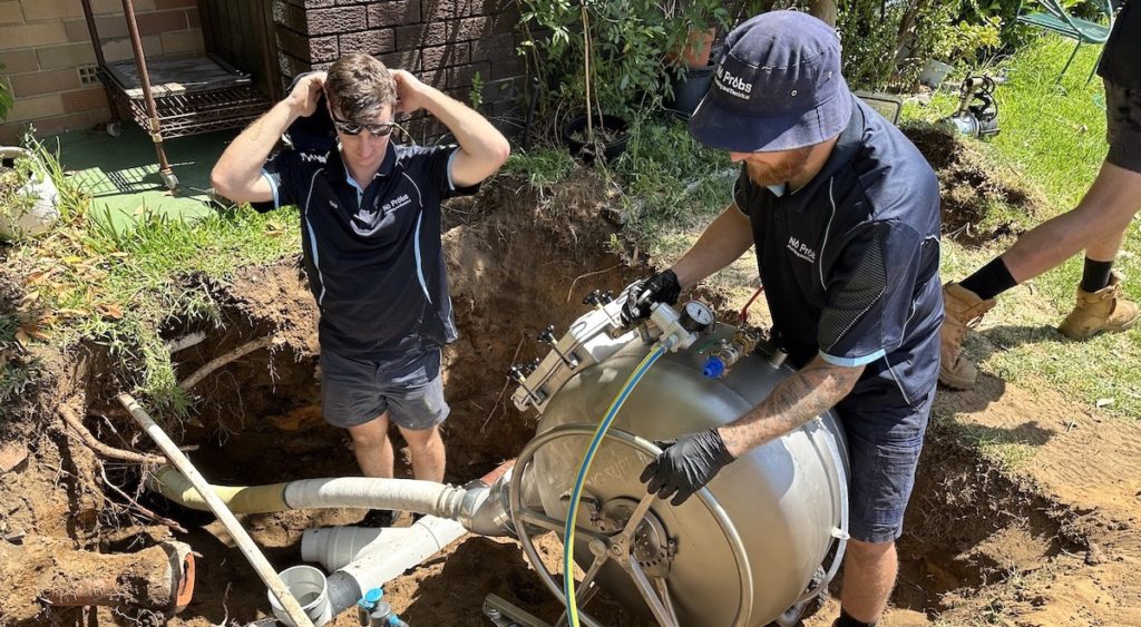 Plumbers relining a damaged sewer pipe in Perth.